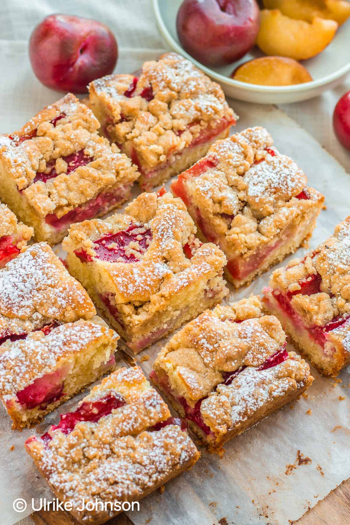 German Plum Crumble Cake without yeast served sliced on a wooden board