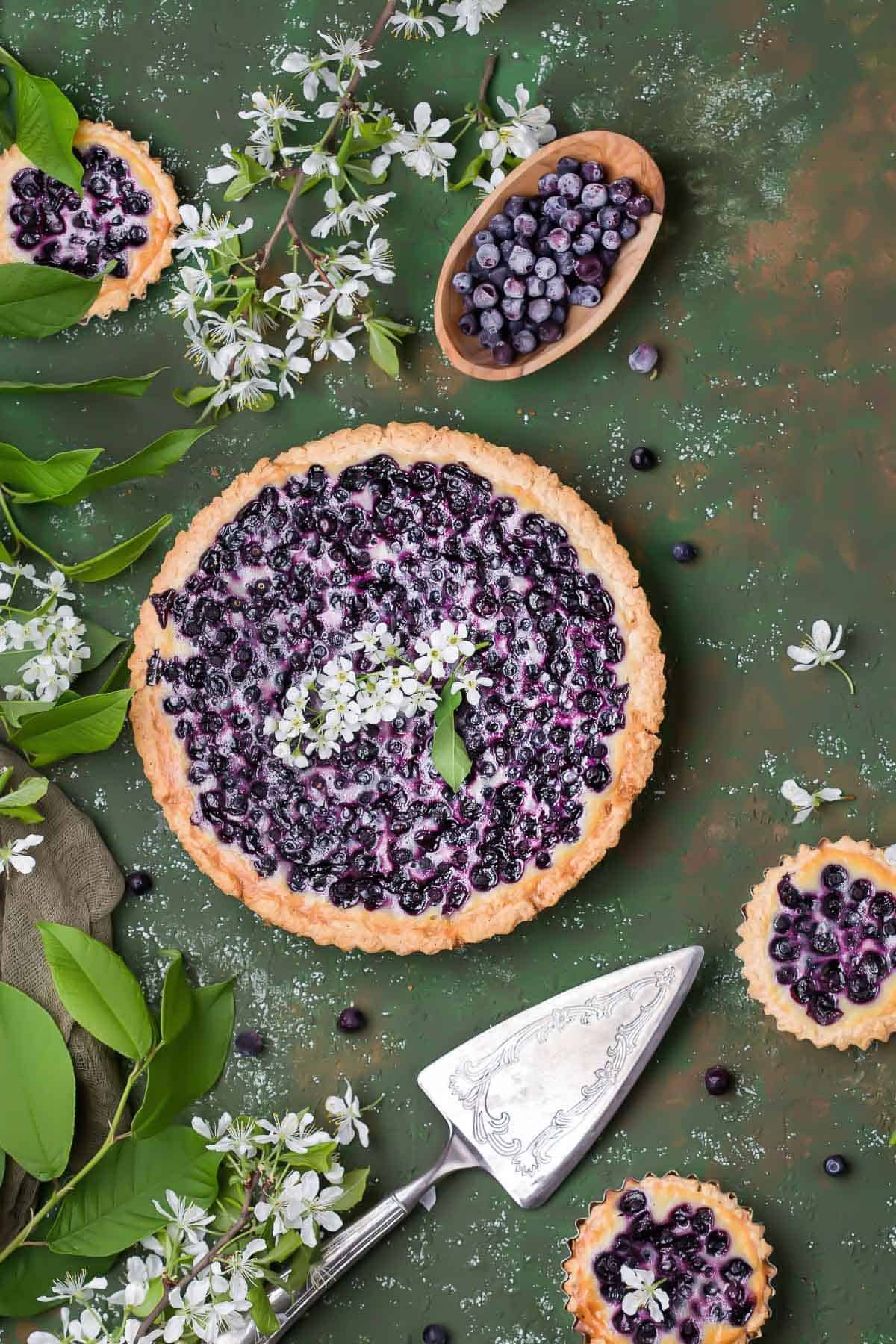 Traditional Finnish Blueberry pie surrounded by twigs and leaves 