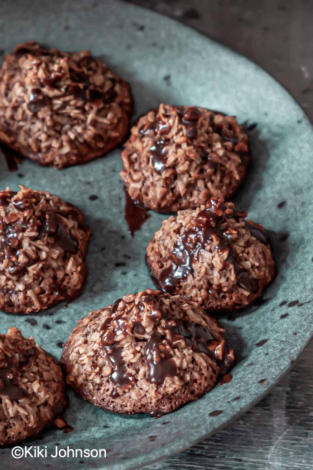 vegan healthy dark chocolate coconut macaroons on a blue plate