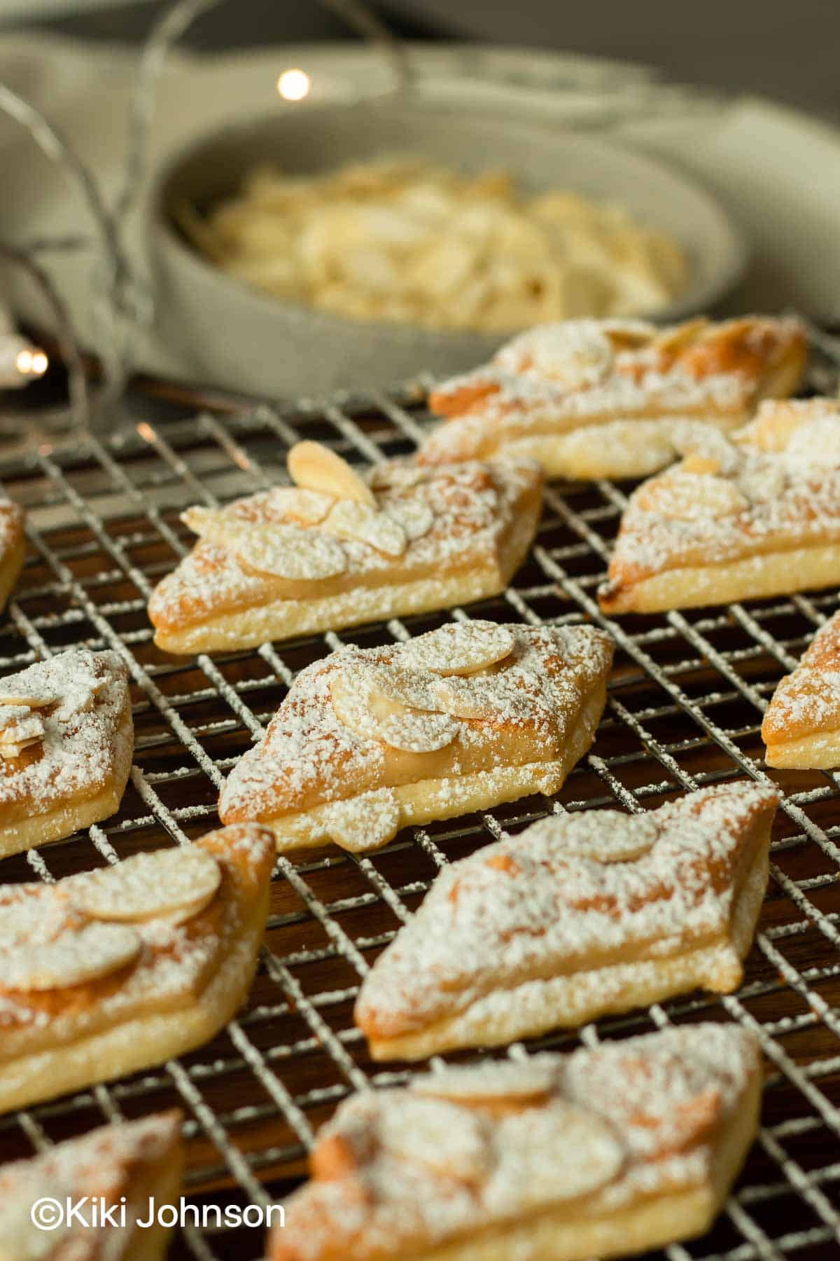 German Almond Cookies with marzipan and slivered almonds on a cake rack