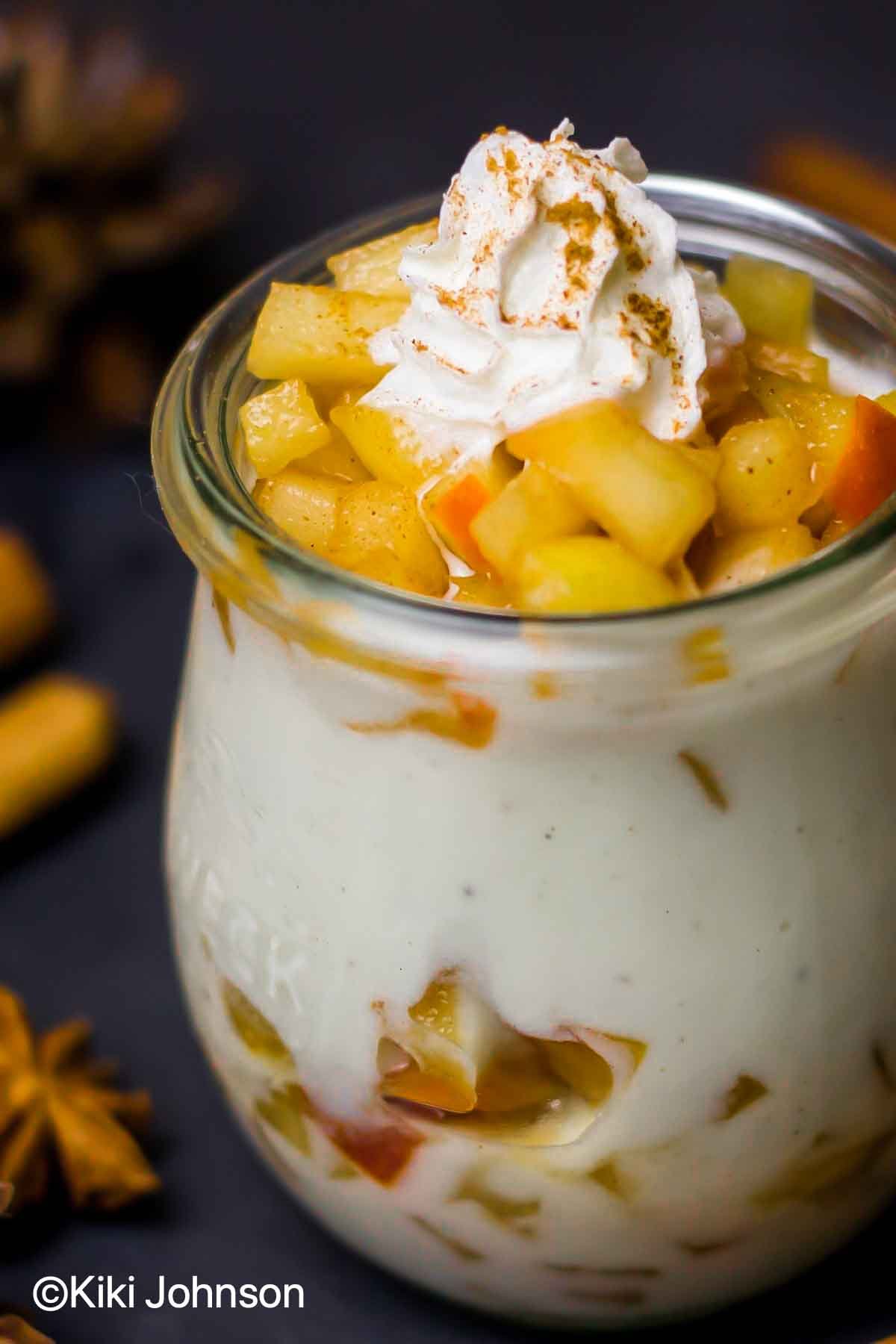easy cinnamon apple mascarpone parfait in a mason jar topped with whipped cream