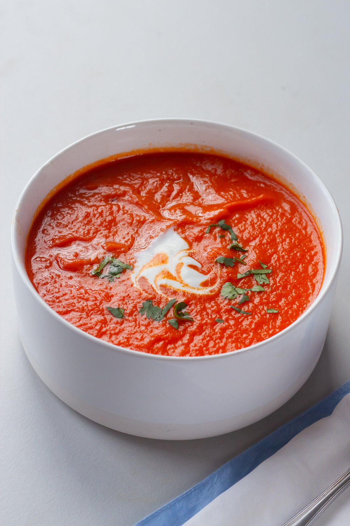 vegan roasted tomato red pepper soup served with a dollop of cashew cream
