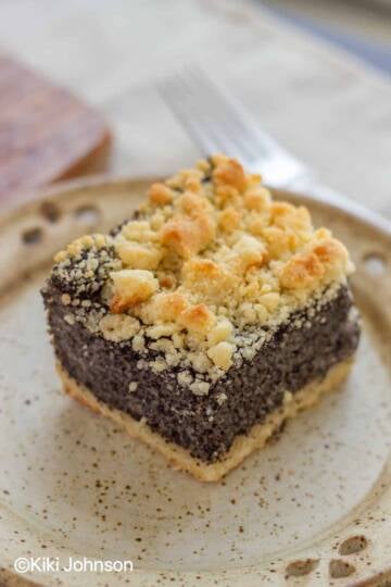 a slice if old fashioned german poppy seed cake with streusel topping
