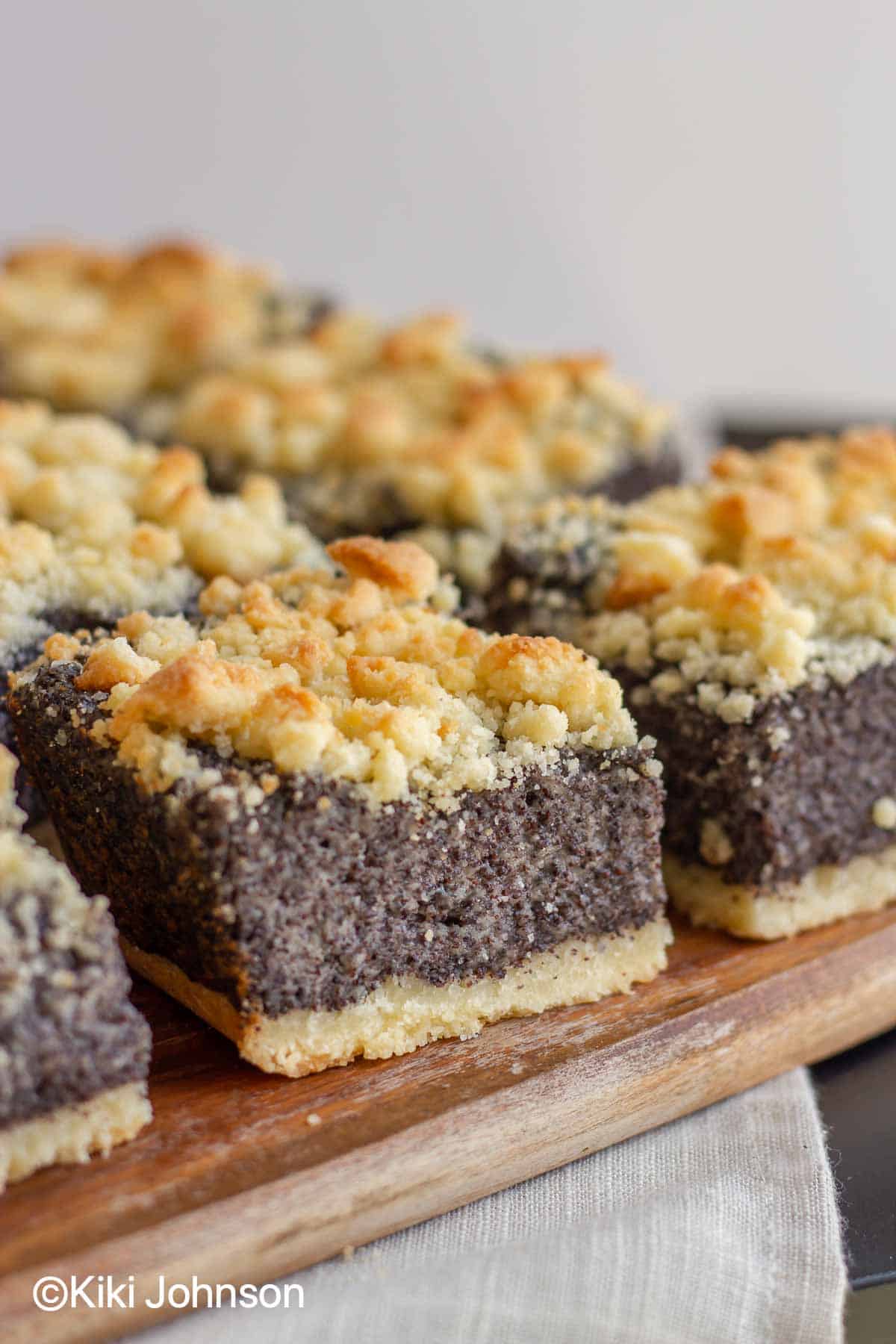 traditional German poppy seed Cake with streusel topping on a wooden board