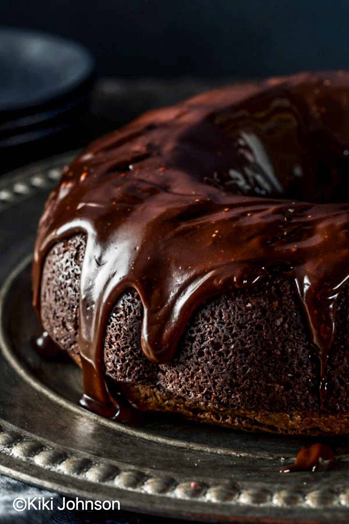 Bourbon Whiskey chocolate cake with whisky drizzle and chocolat frosting on a cake platter