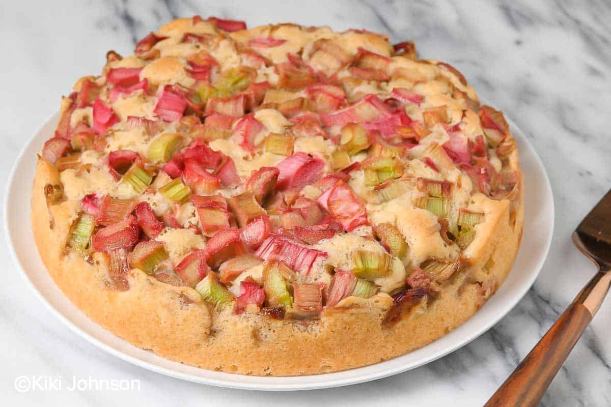 traditional German rhubarb cake baked in a springform pan served on a cake plate