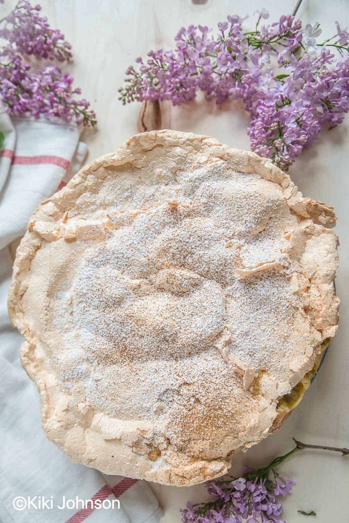 Traditional German Rhubarb Meringue Cake surrounded with lilac flowers
