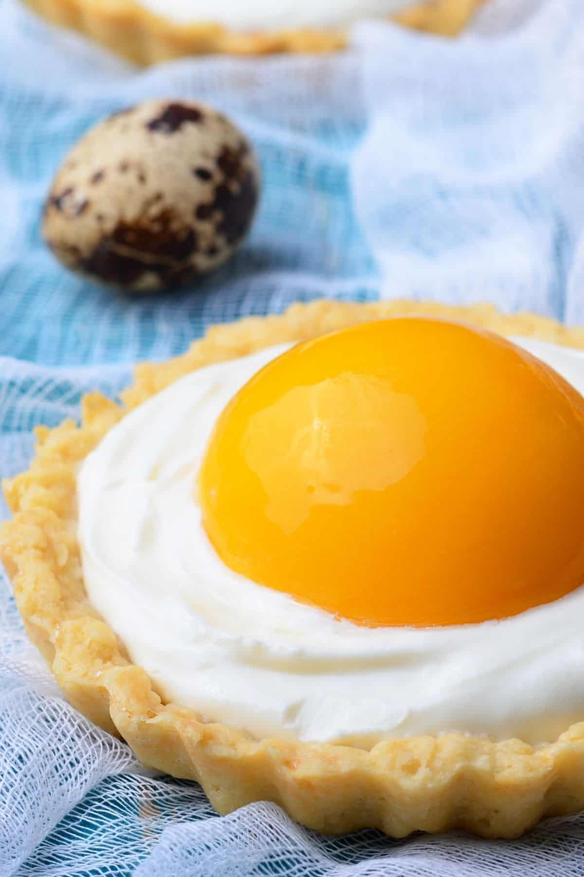 close-up of a sunny side up tart topped with a halved apricot