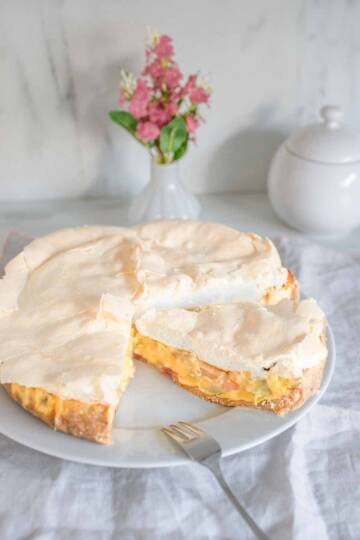 German Rhubarb Sour Cream Custard Pie with Meringue Topping on a cake platter