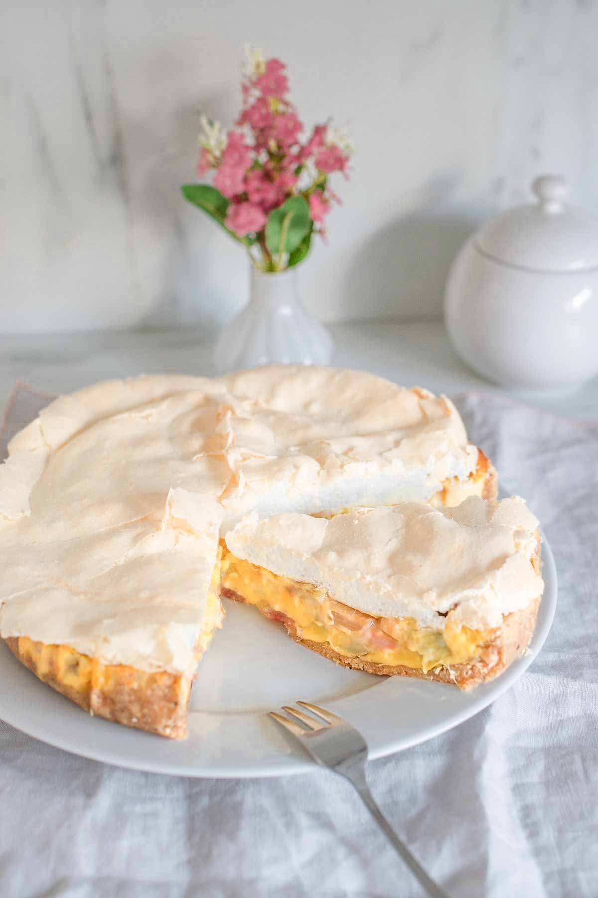 sliced Amish german rhubarb meringue pie with sour cream custard on a cake platter