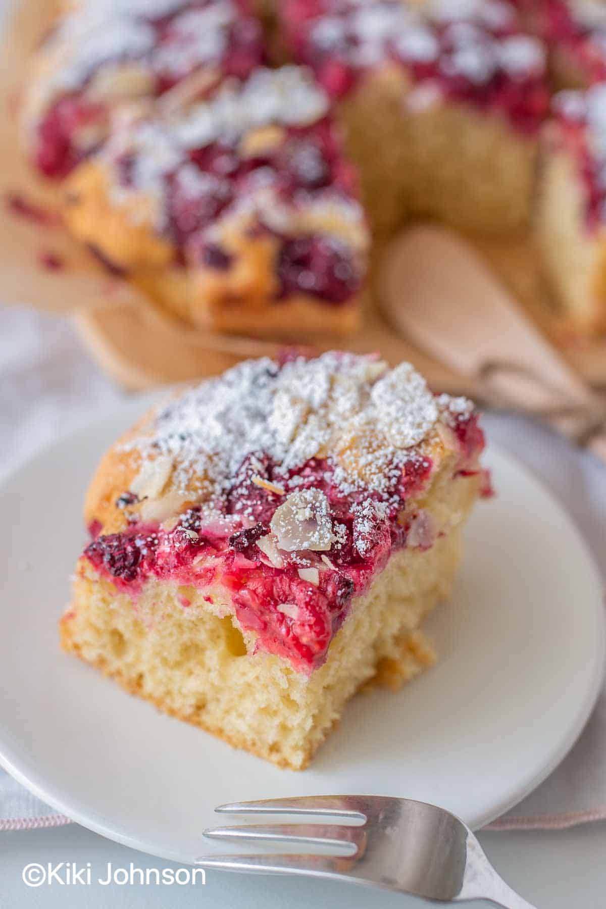 close-up of a piece of raspberry coffee cake on a cake plate