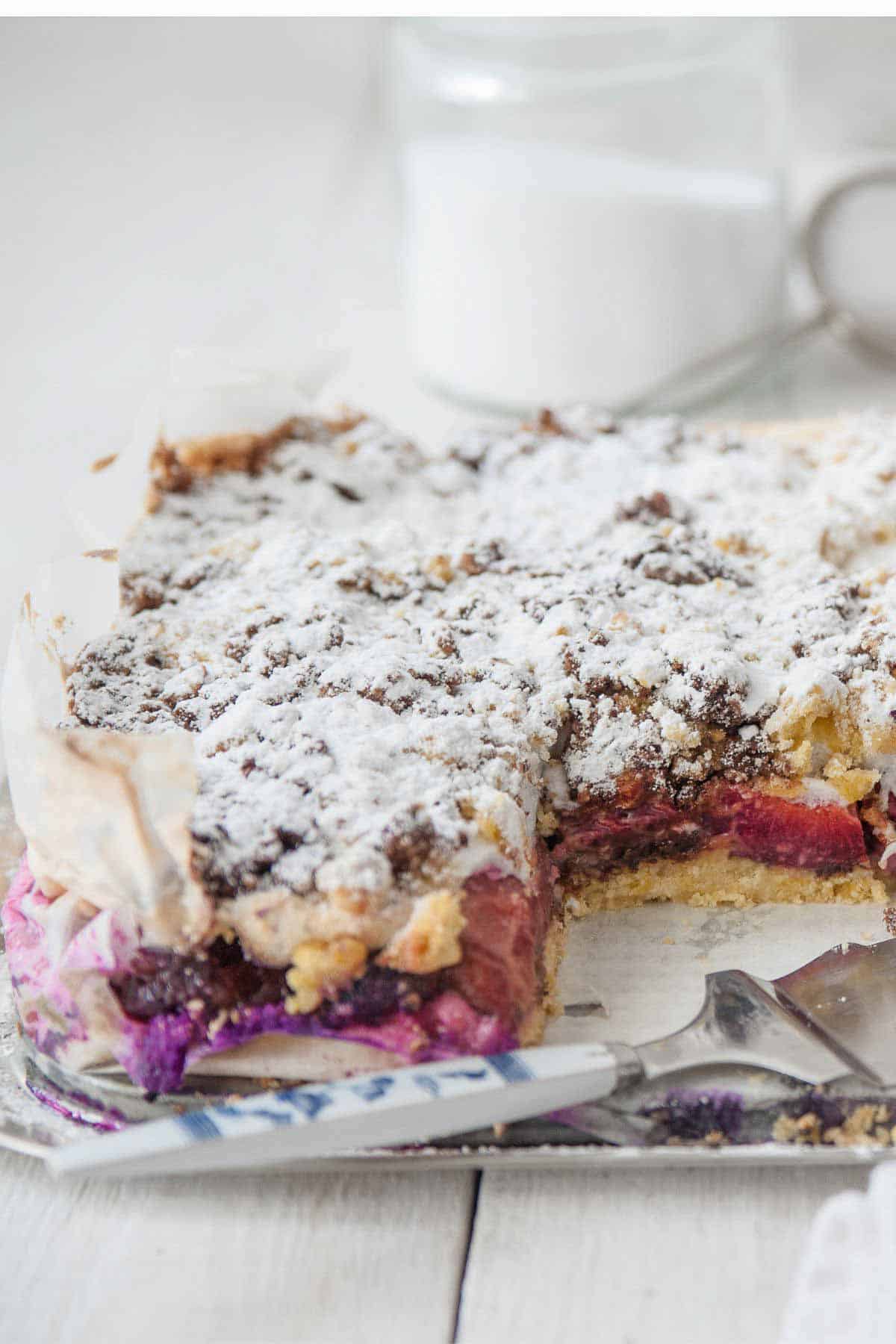 side view of a prune plum coffee cake made with Italian plums topped with meringue and streusel