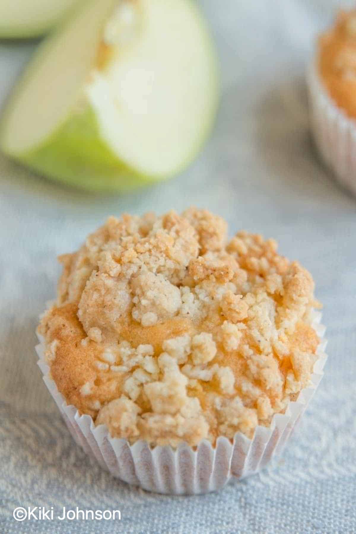 German Apple Streusel Muffins with crumb topping on a cloth napkin