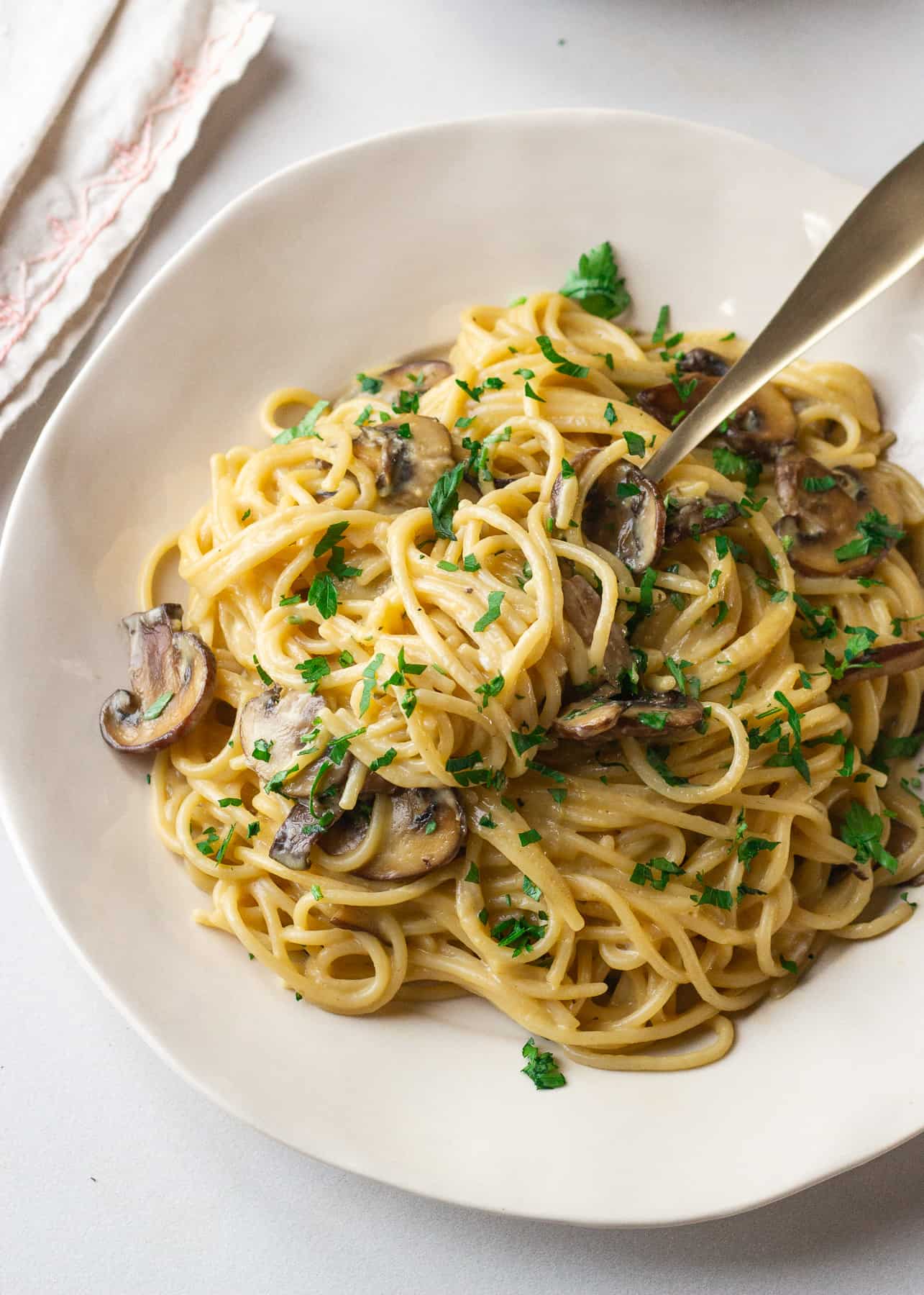 a. fork twirling lactose free pasta carbonara with mushrooms 