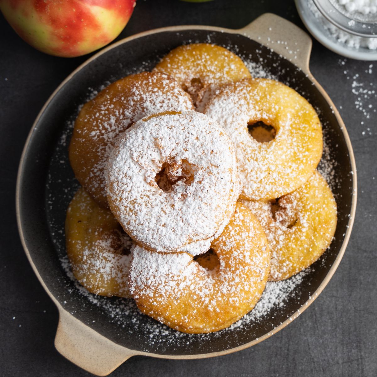 German apple fritters on a black plate