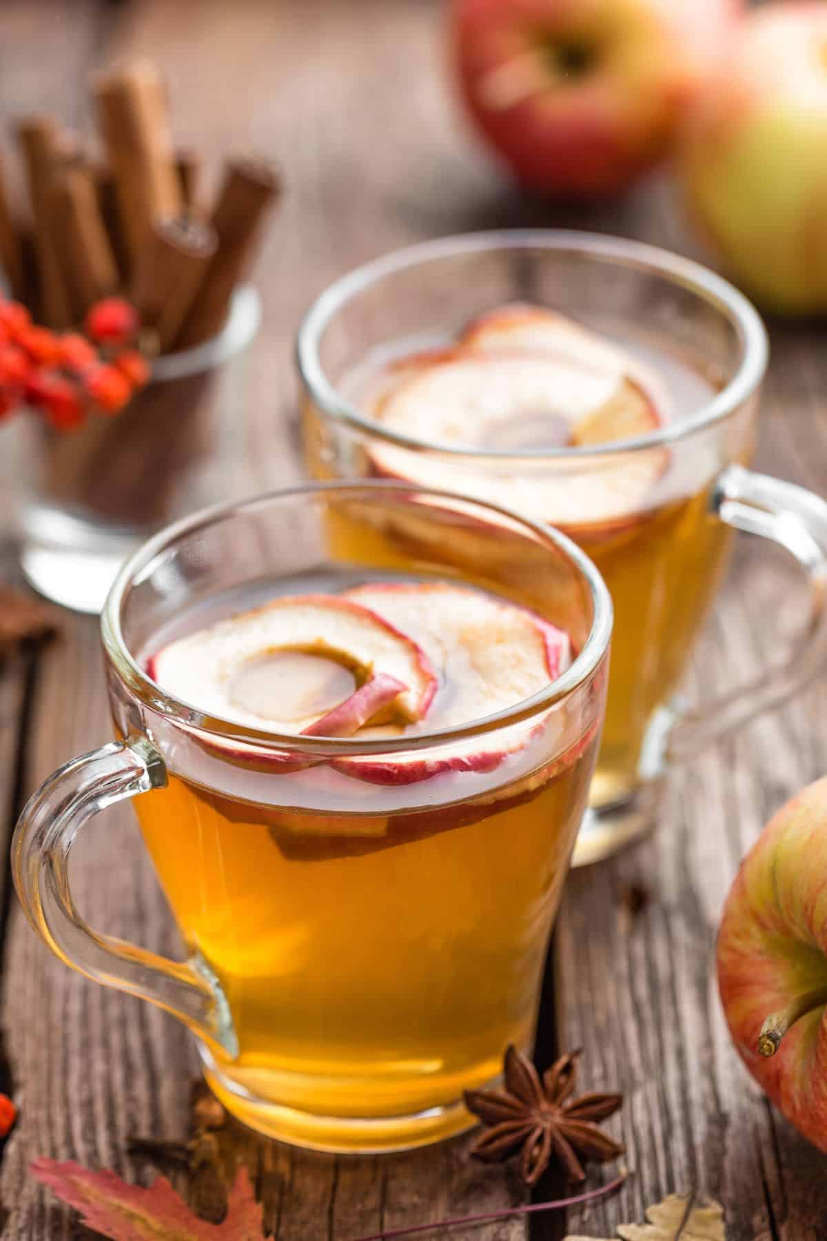 two glasses of German mulled white wine with apple slices 