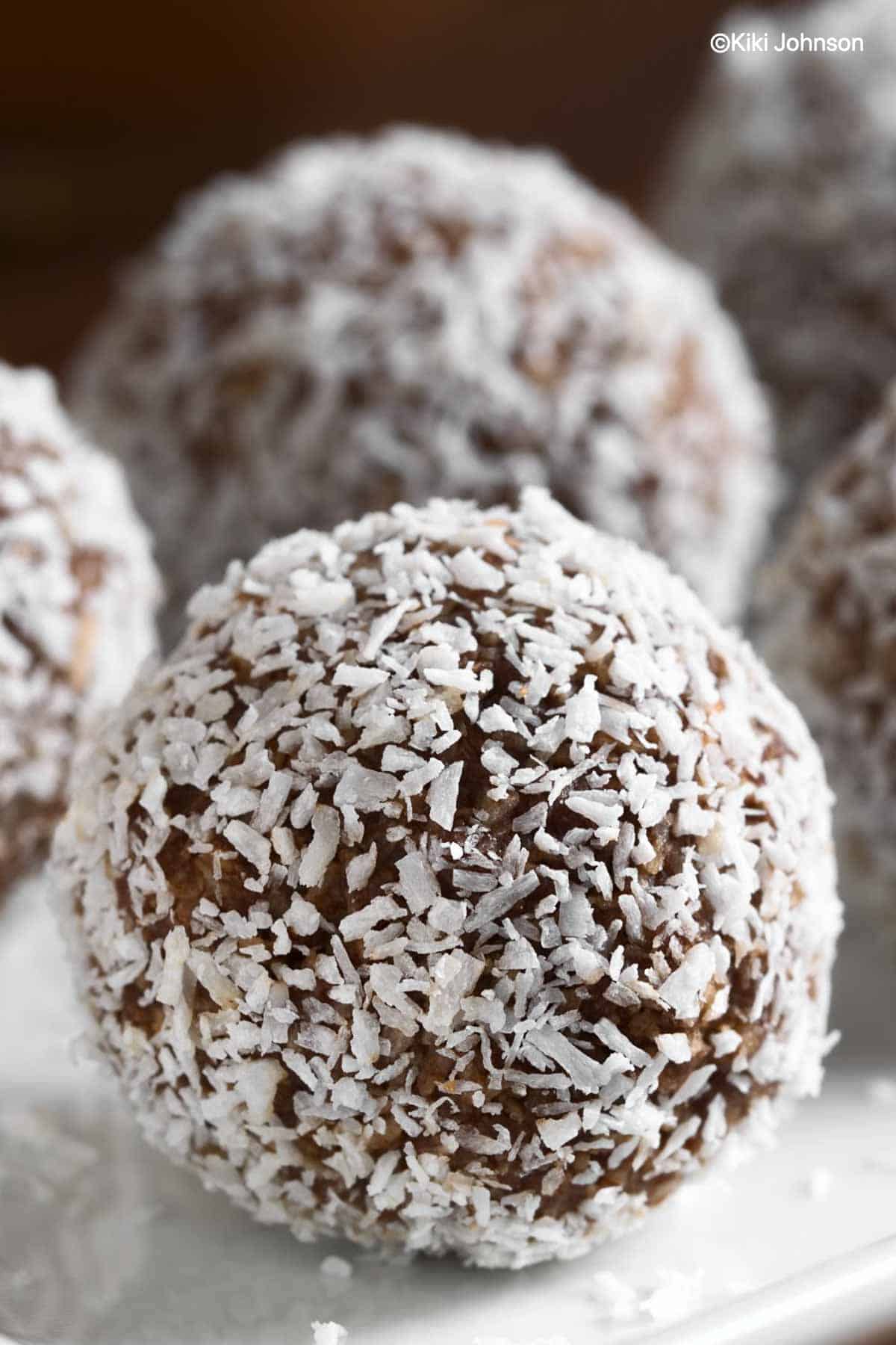 German Rum Balls rolled in coconut flaked on a plate