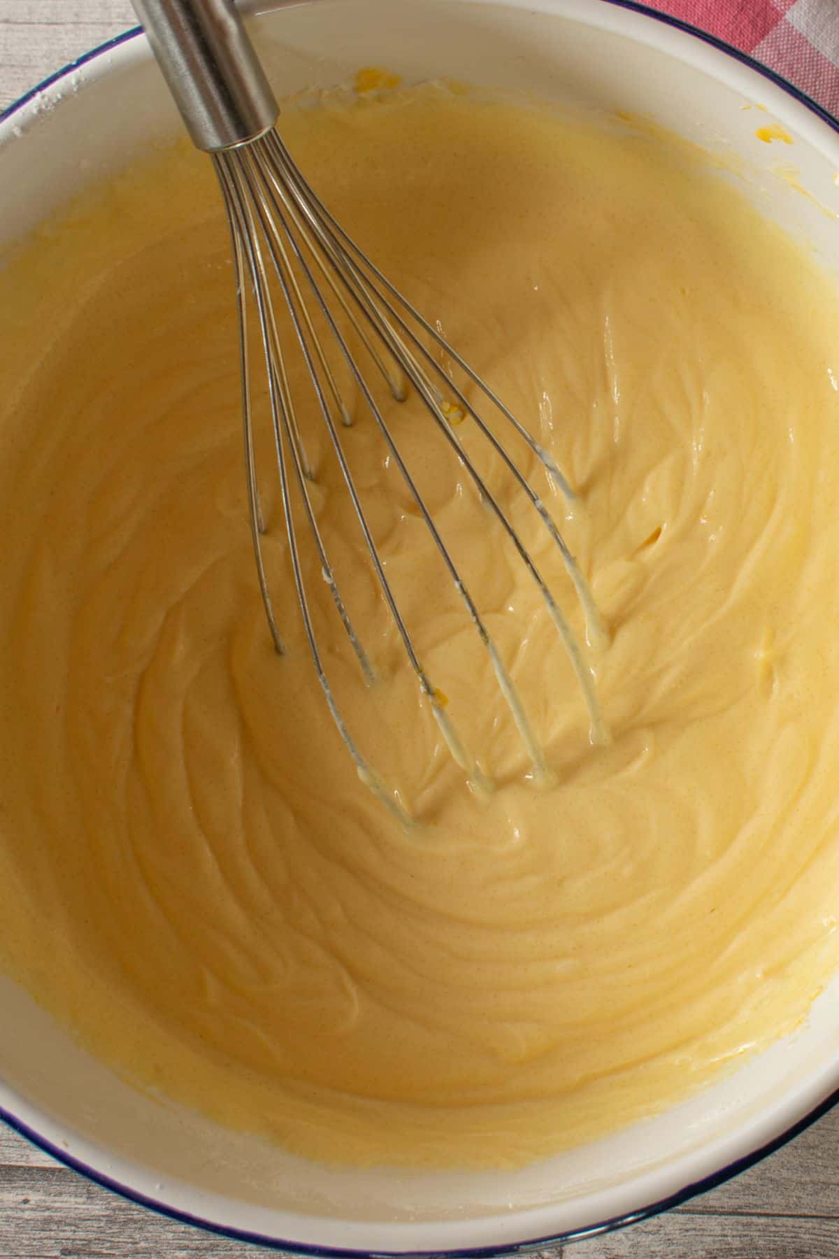 a bowl with German vanilla pudding with a whisk
