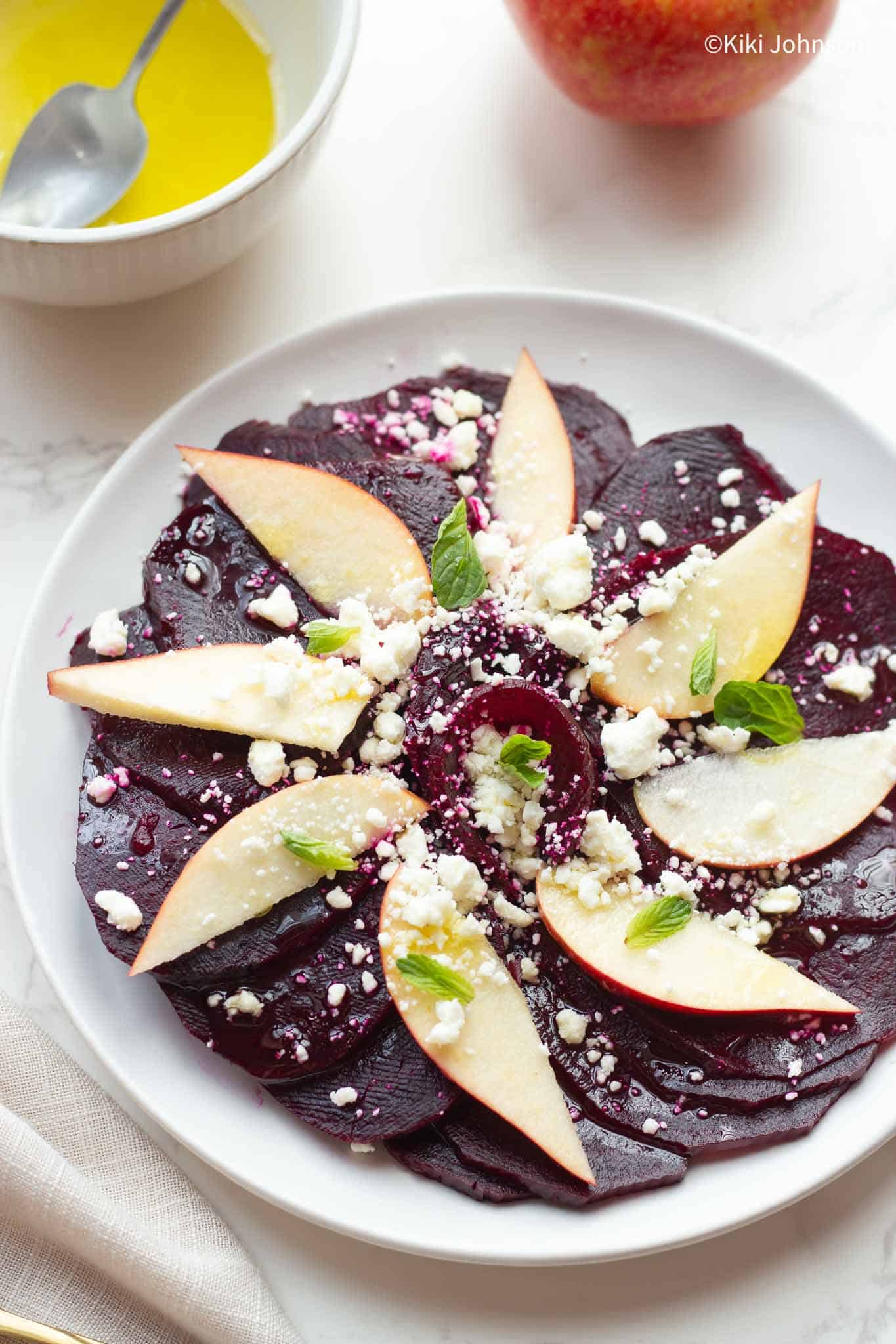 a platter with beet salad with apple and feta cheese 