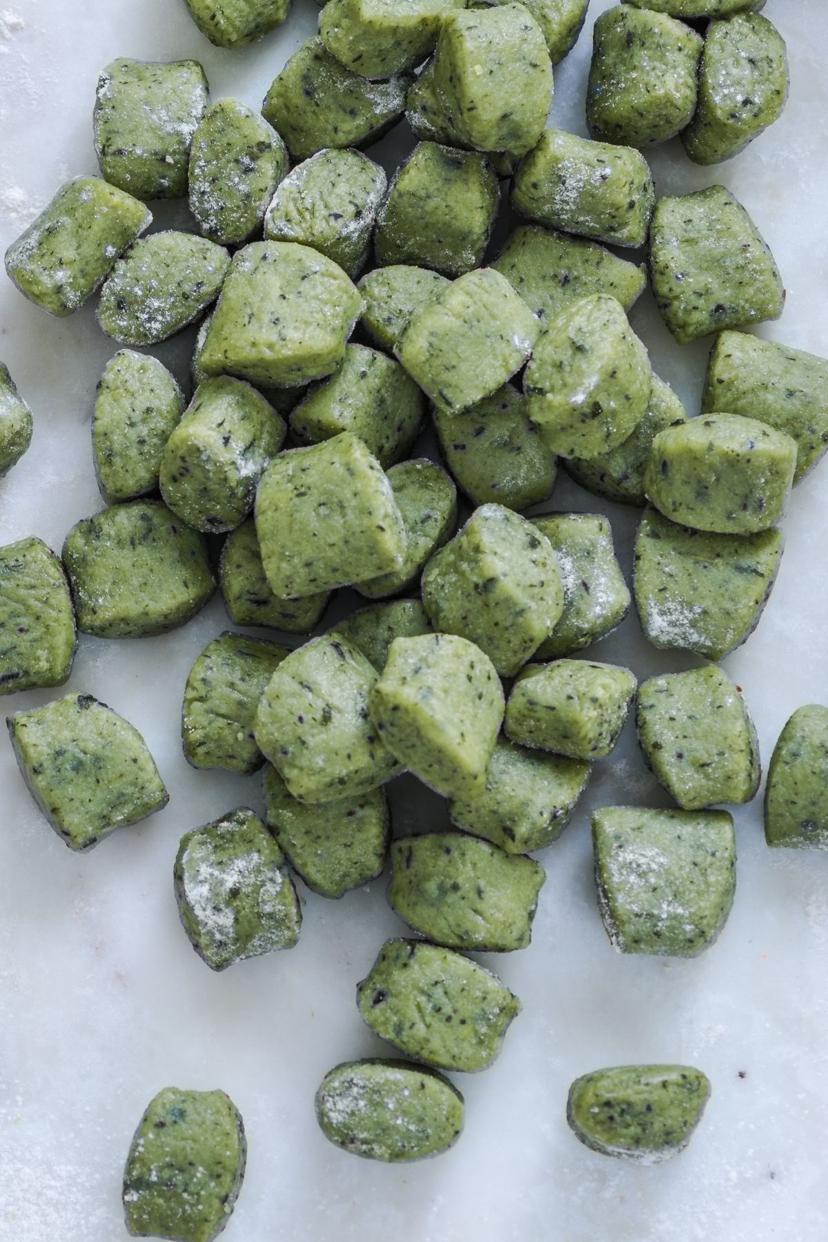 vegan wild garlic gnocchi on a marble countertop 