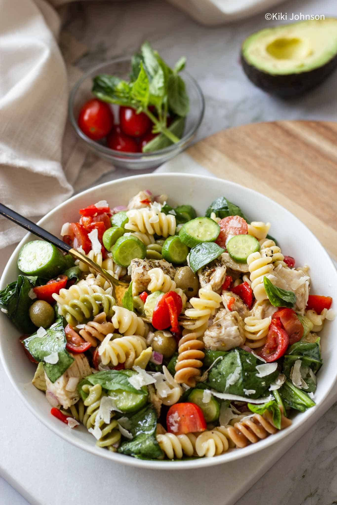 chicken pesto pasta salad with vegetables and fresh basil 