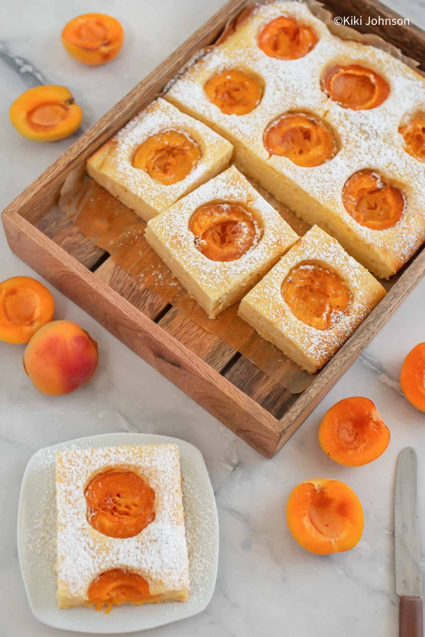 German fresh apricot sponge cake baked on a sheet pan and cut into slices.