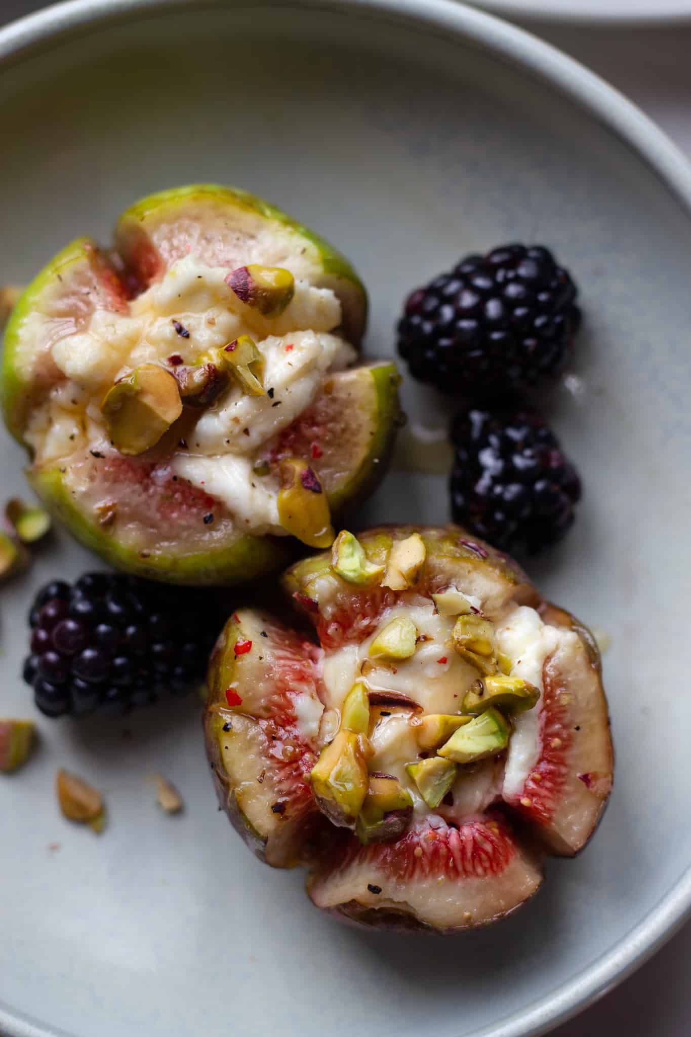 Roasted Figs stuffed with goat cheese and drizzled with honey and pistachios.