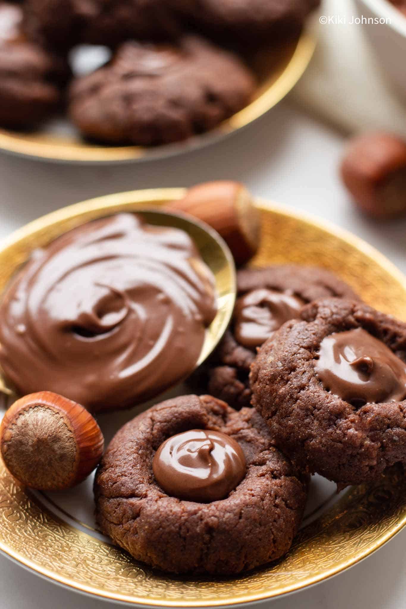 a plate with nutella thumbprint cookies with soft center