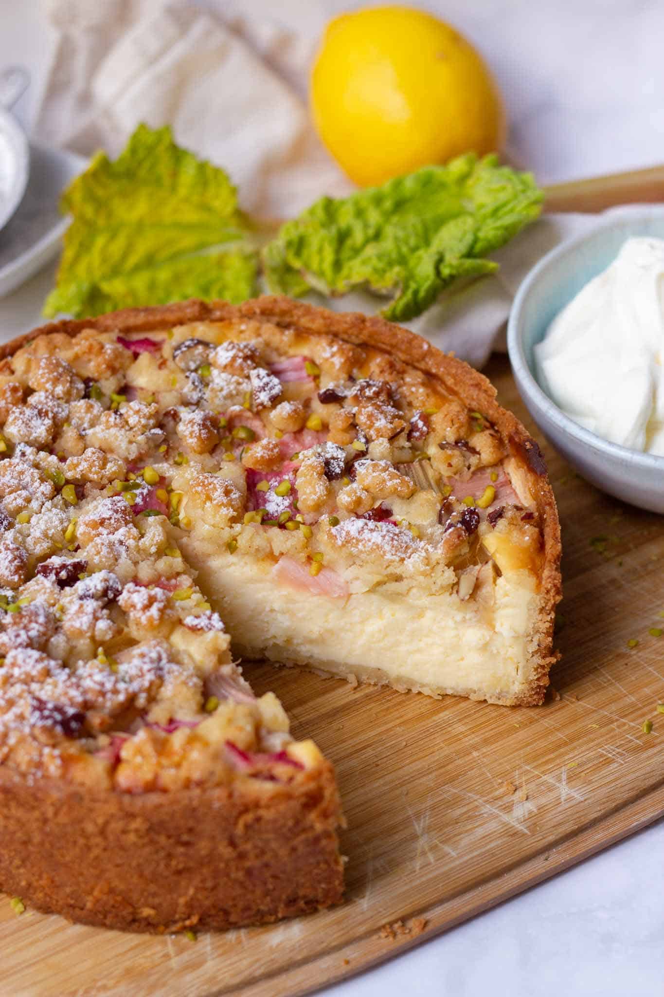 A sliced german rhubarb cheesecake from the springform pan with streusel.