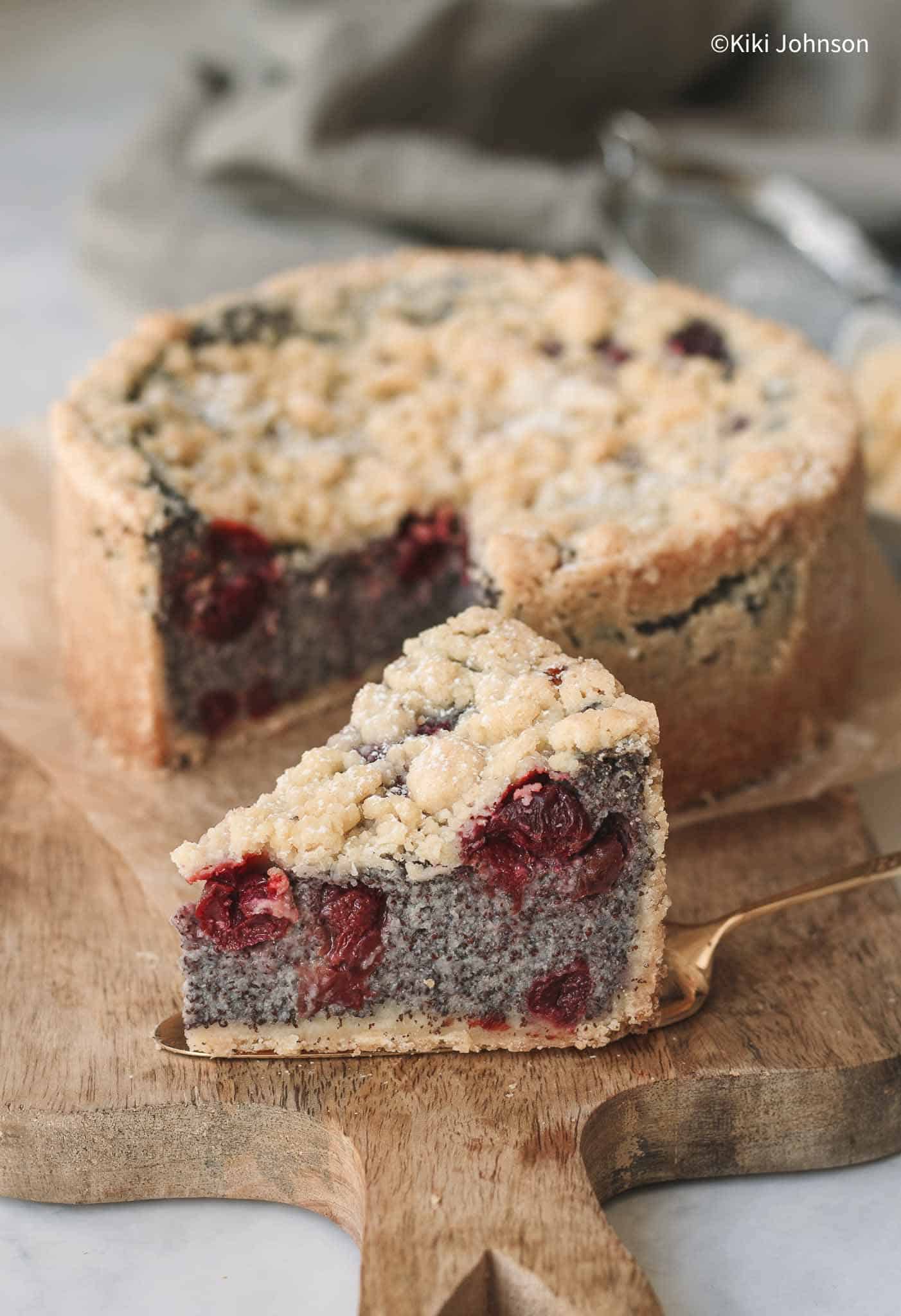 a slice of German Mohnkuchen Poppy seed cake with cherries and streusel topping
