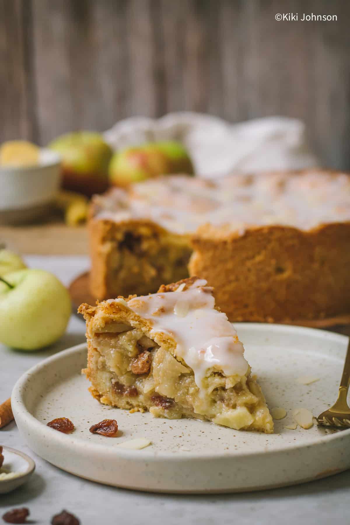 a slice of German Apple Pie with lemon glaze and almond slivers