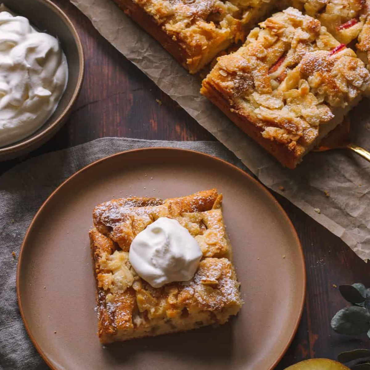 a piece of German apple sheet cake on a brown plate