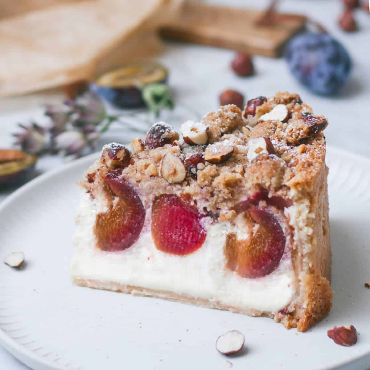 a slice of German Plum Cheesecake with Hazelnut Crumble Topping