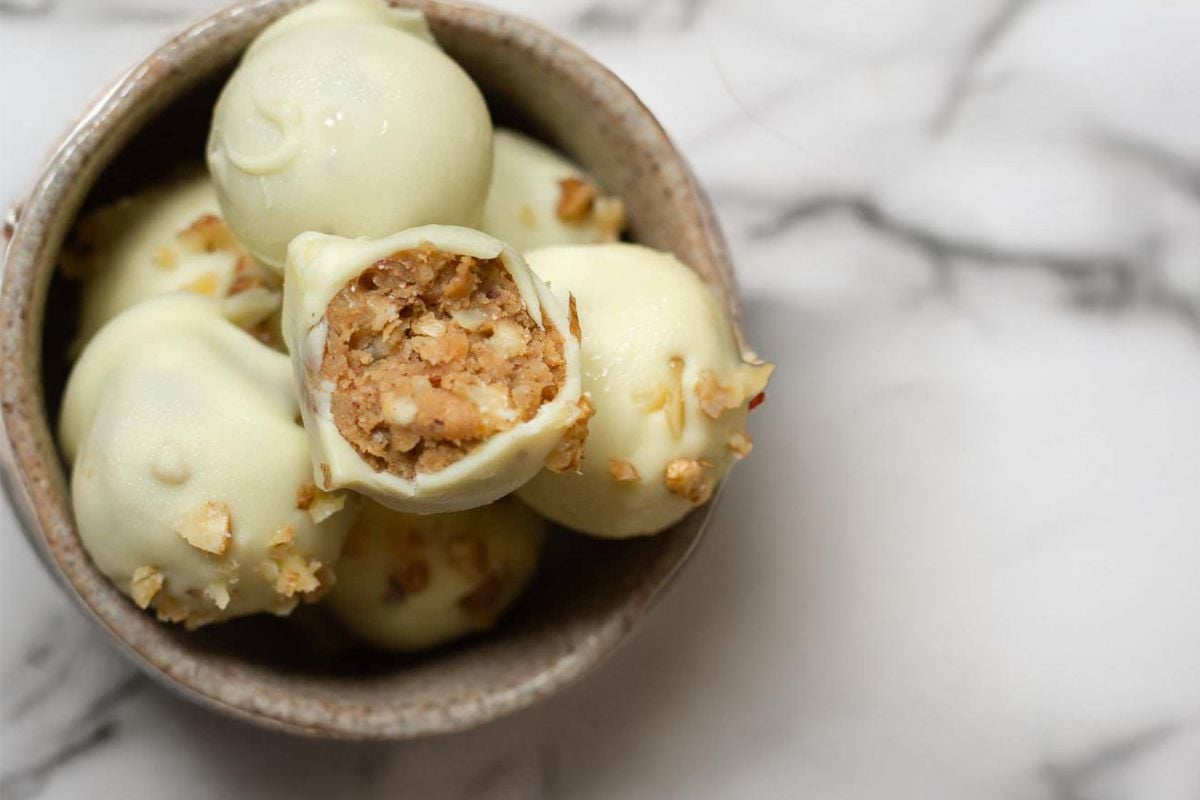 a small bowl with apple cinnamon truffles ( apple pie truffles) with dried apples, cream cheese and cookie crumbs