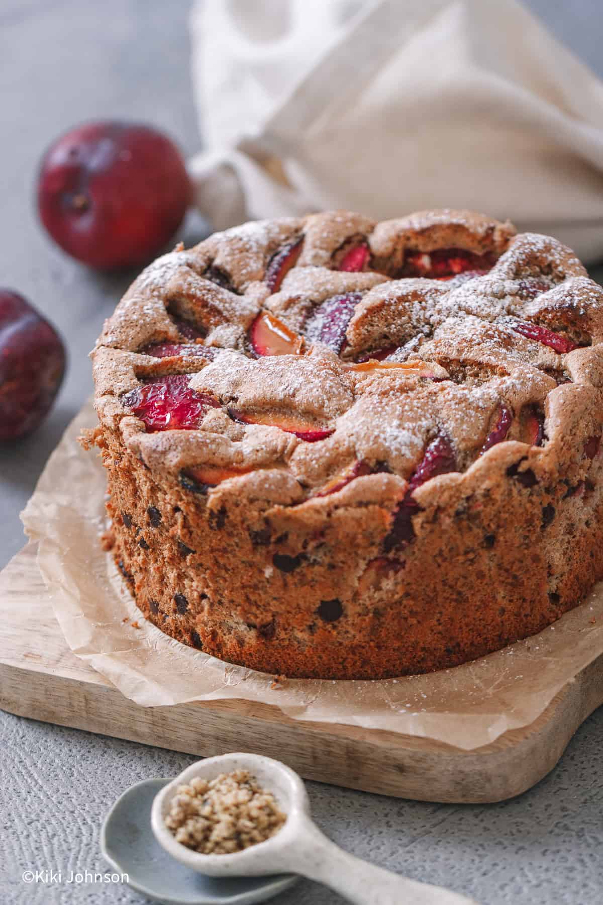 a spiced walnut cake with plum slices baked into the batter and chocolate chips folded into the batter