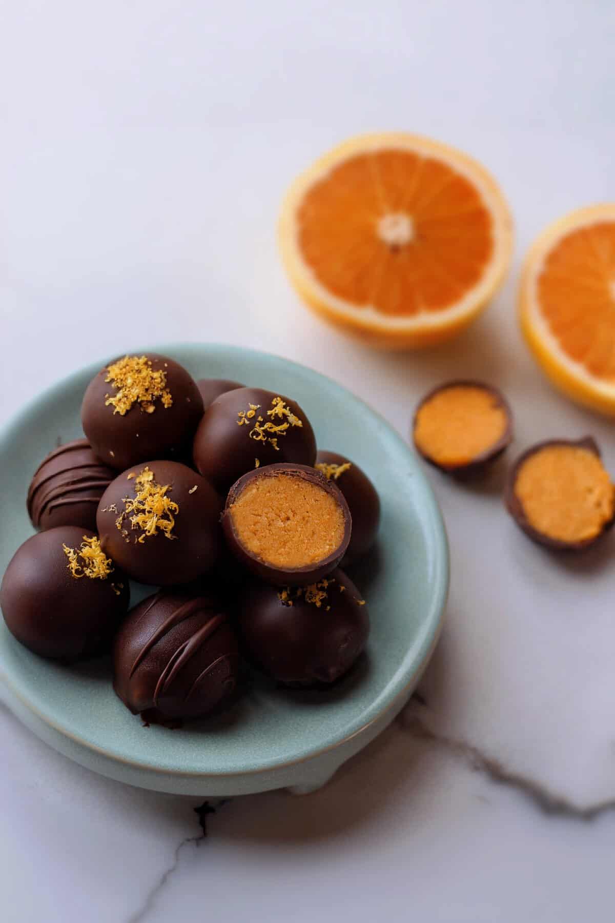 eine schale mit Orangen Pralinen mit dunkler Schokolade überzogen