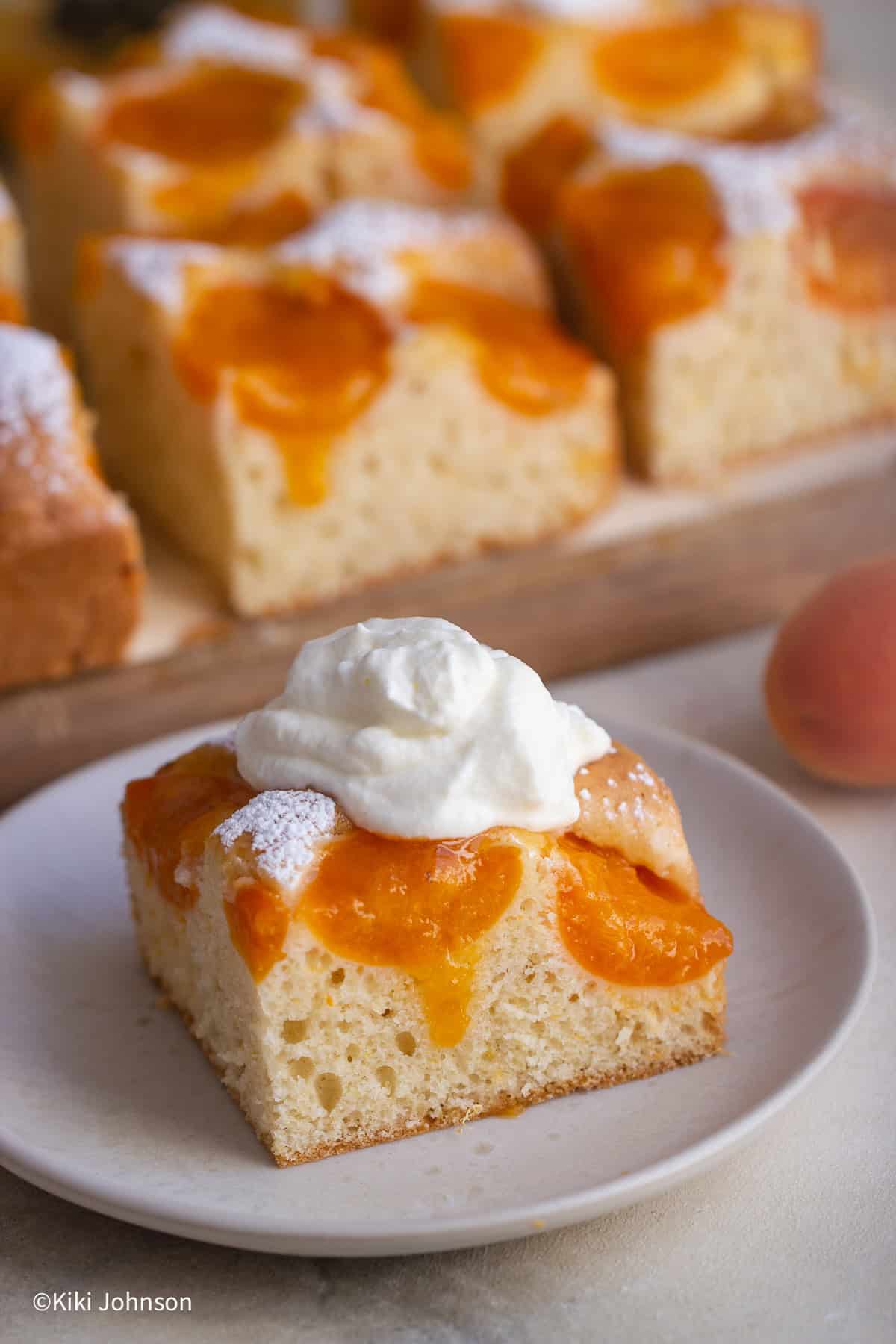 a piece of Austrian Apricot Cake served with whipped creqam 