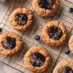 blueberry pie cookies with blueberry jam filling on a golden rack